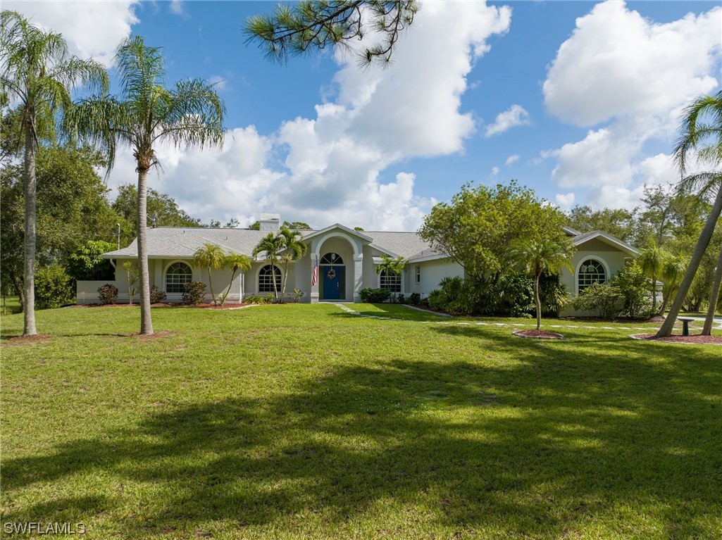 17571 Oak Creek Road Alva, FL 33920 - Photo 33 of 49 a front view of a house with a yard