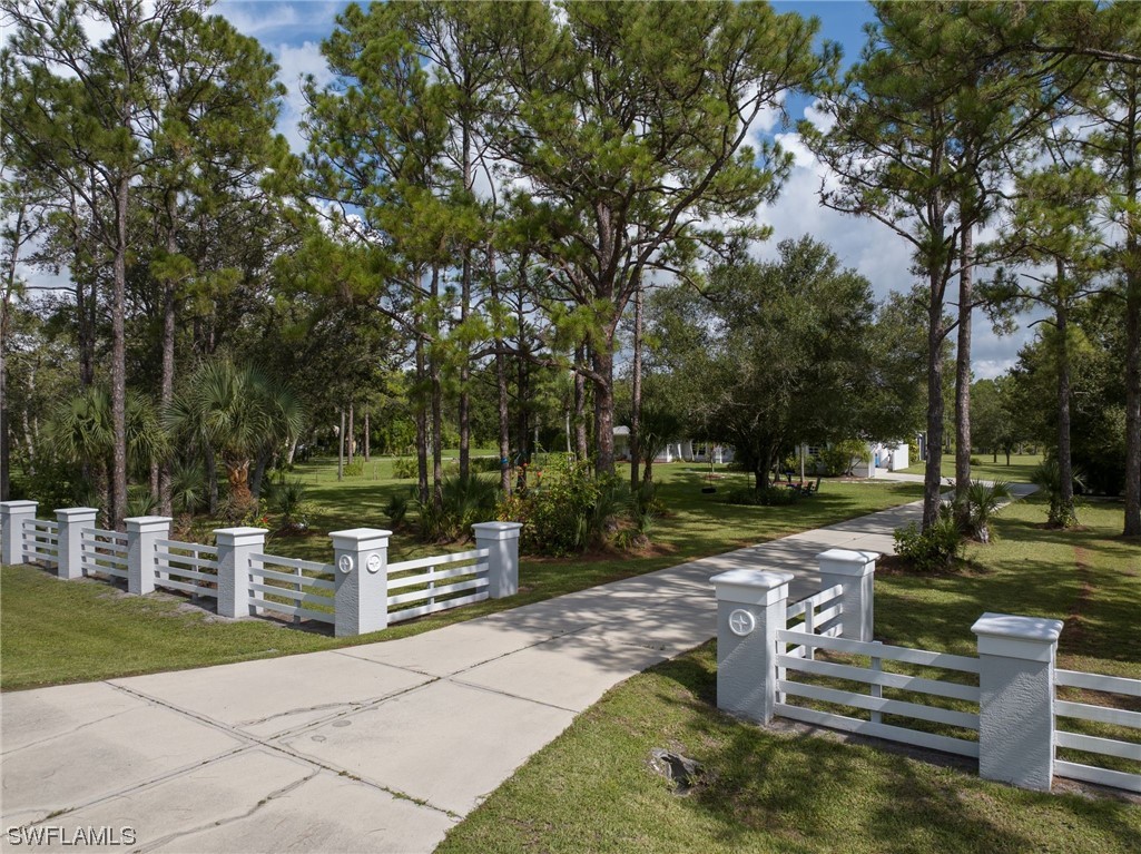 17571 Oak Creek Road Alva, FL 33920 - Photo 41 of 49 a view of a garden with wooden benches