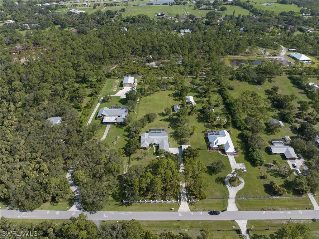 17571 Oak Creek Road Alva, FL 33920 - Photo 47 of 49 an aerial view of residential houses with outdoor space and trees