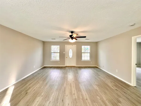 wooden floor in an empty room with a window