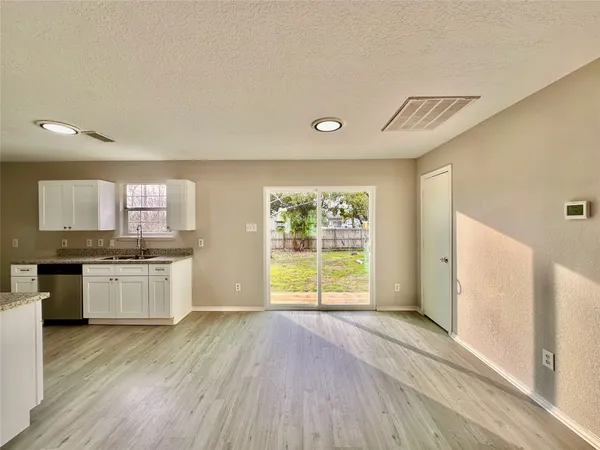 a kitchen with a wooden floor and window