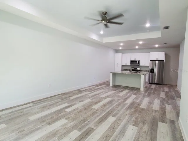 a view of a kitchen with a sink and a refrigerator