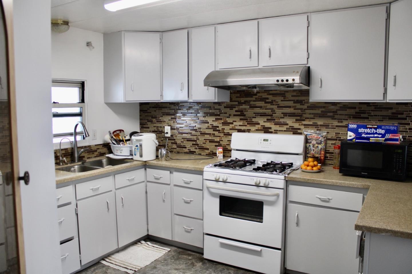 1358 Oakland Road, Unit 47 San Jose, CA 95112 - Photo 2 of 9 a kitchen with white cabinets and white appliances