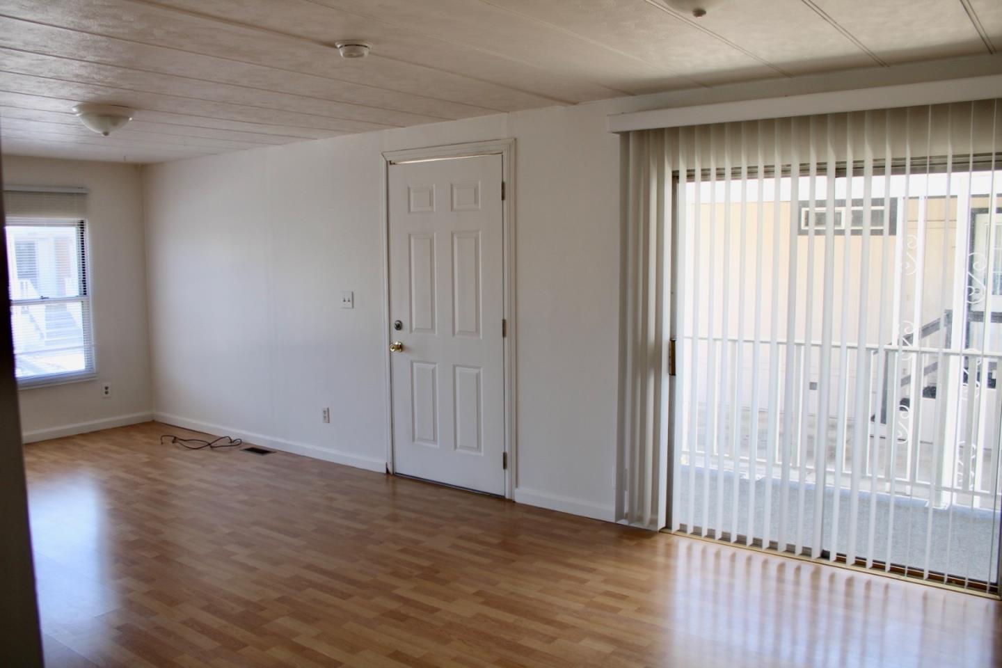1358 Oakland Road, Unit 47 San Jose, CA 95112 - Photo 3 of 9 an empty room with wooden floor and windows