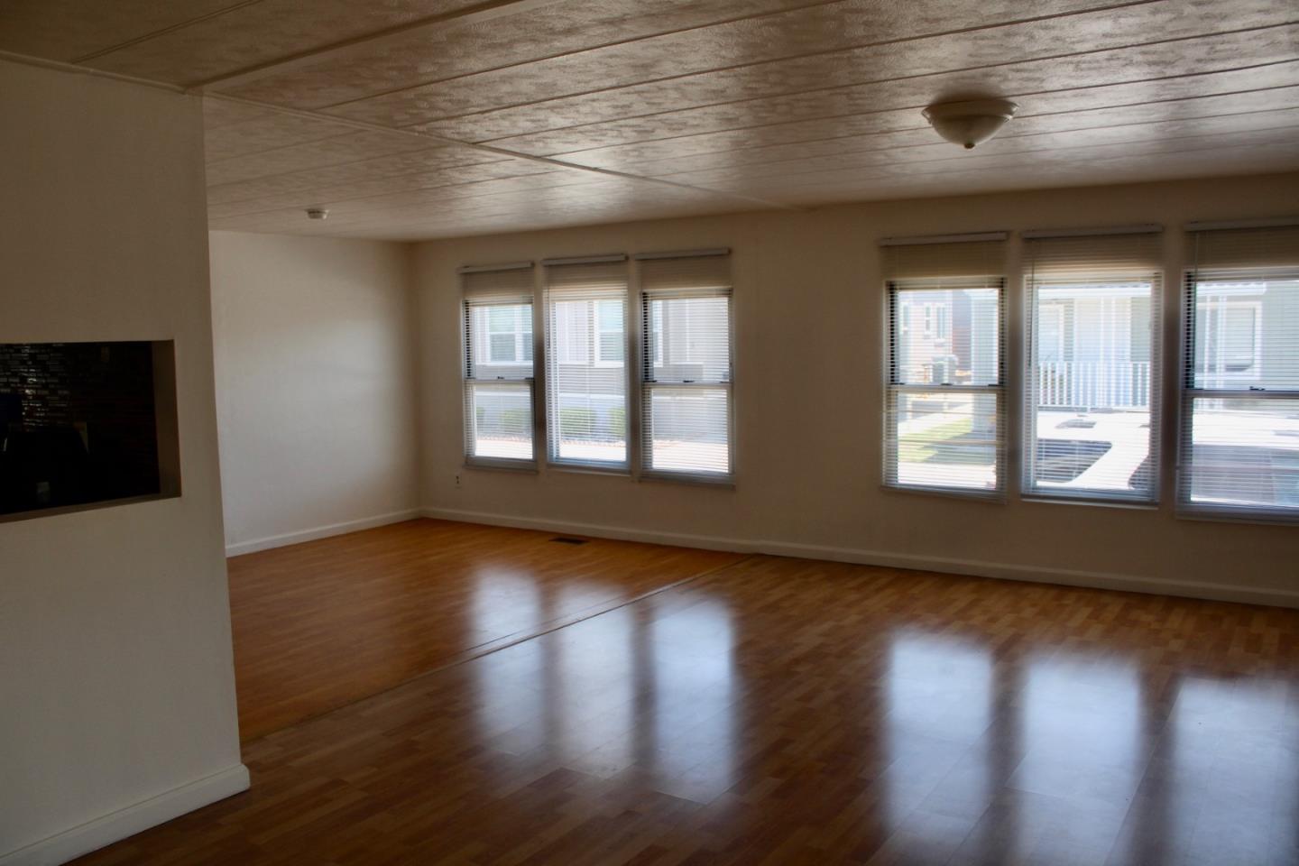 1358 Oakland Road, Unit 47 San Jose, CA 95112 - Photo 4 of 9 a view of an empty room with wooden floor and a window