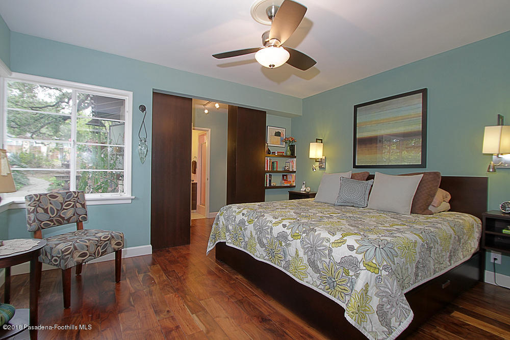 3775 Shadow Grove Road Pasadena, CA 91107 - Photo 15 of 33 a bedroom with a bed and a chandelier