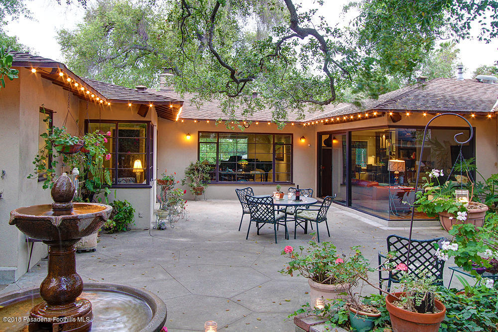 3775 Shadow Grove Road Pasadena, CA 91107 - Photo 27 of 33 a view of a patio with table and chairs potted plants and a large tree