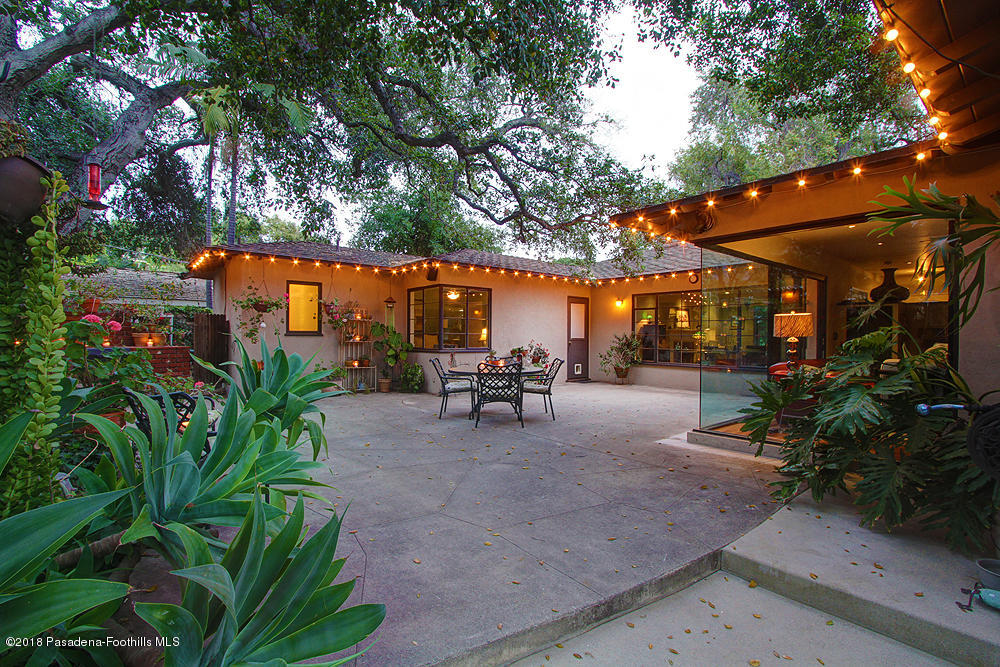 3775 Shadow Grove Road Pasadena, CA 91107 - Photo 31 of 33 a view of a patio with table and chairs potted plants and large tree