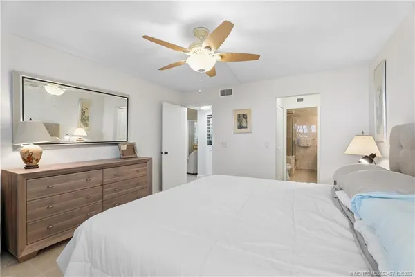 a bedroom with a large bed mirror and furniture