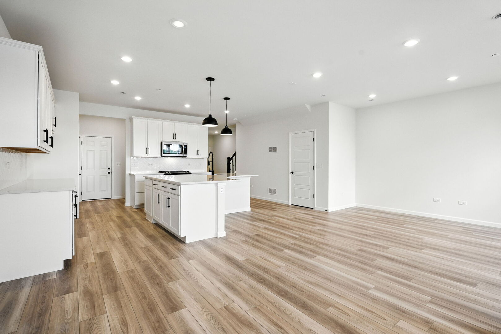 1062 Houston Street, Unit 74004 Batavia, IL 60510 - Photo 11 of 23 a large kitchen with stainless steel appliances a large counter top a stove and a refrigerator