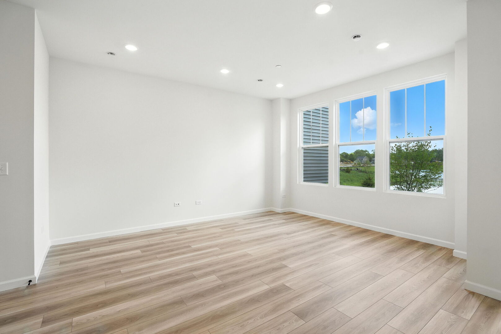 1062 Houston Street, Unit 74004 Batavia, IL 60510 - Photo 12 of 23 a view of an empty room with wooden floor and a window