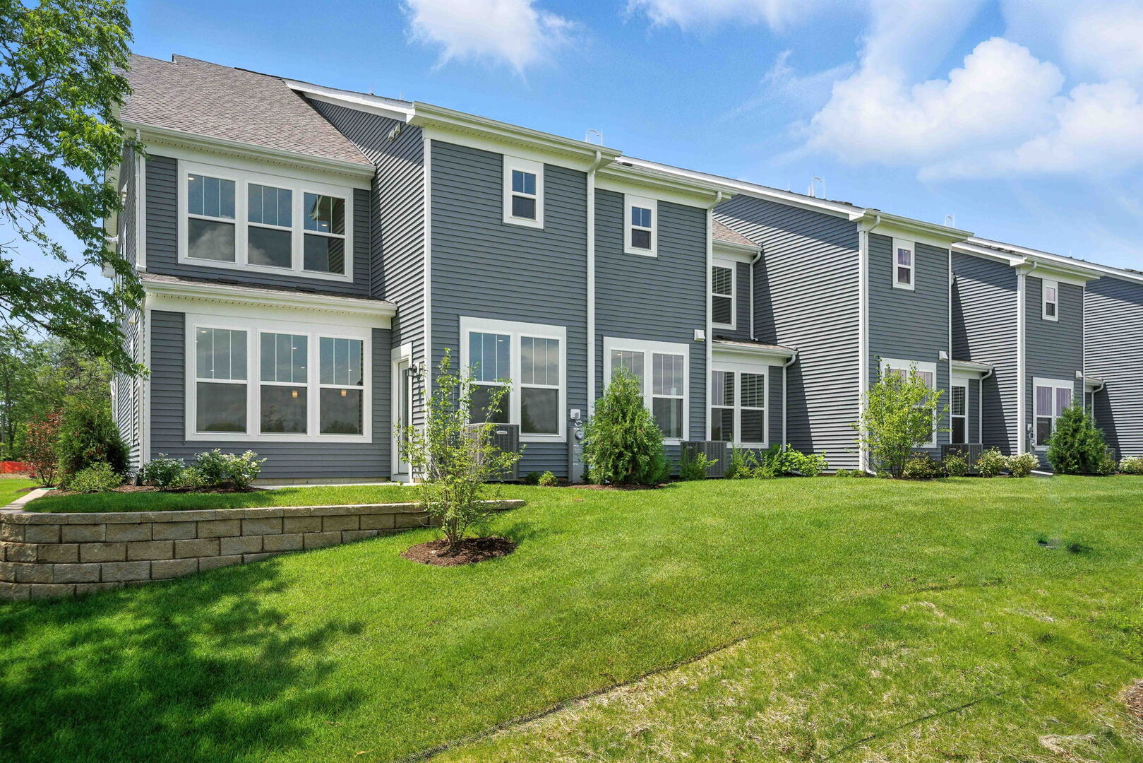 1062 Houston Street, Unit 74004 Batavia, IL 60510 - Photo 2 of 23 a front view of a house with a yard