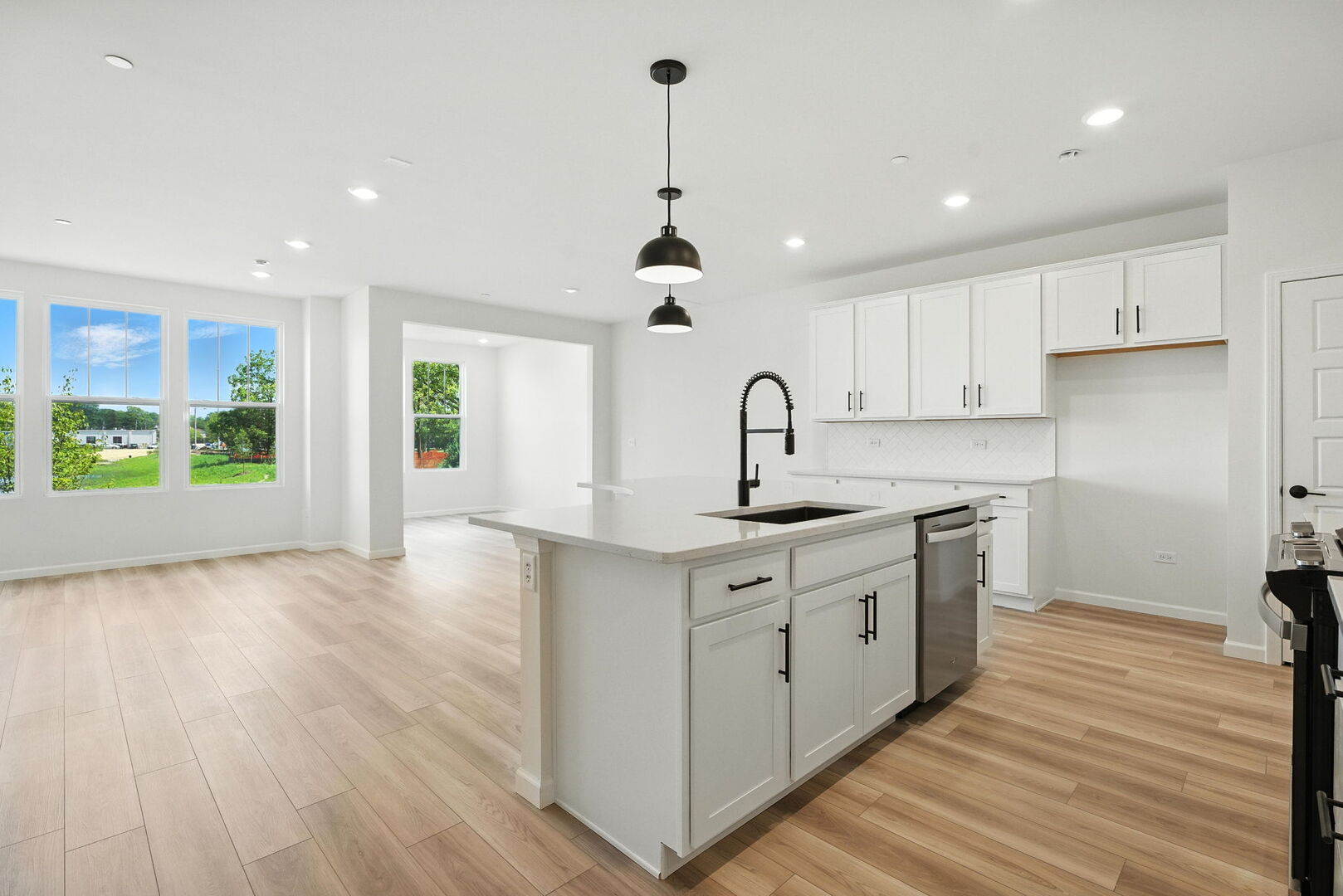 1062 Houston Street, Unit 74004 Batavia, IL 60510 - Photo 3 of 23 a kitchen with stainless steel appliances granite countertop a sink a stove a refrigerator and cabinets