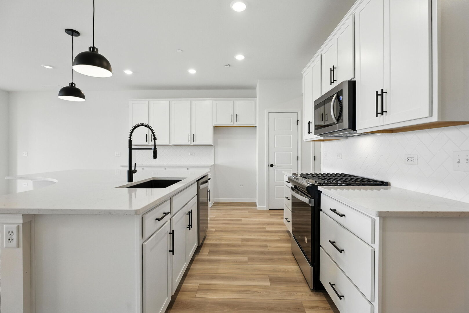 1062 Houston Street, Unit 74004 Batavia, IL 60510 - Photo 4 of 23 a kitchen with white cabinets stainless steel appliances and a sink