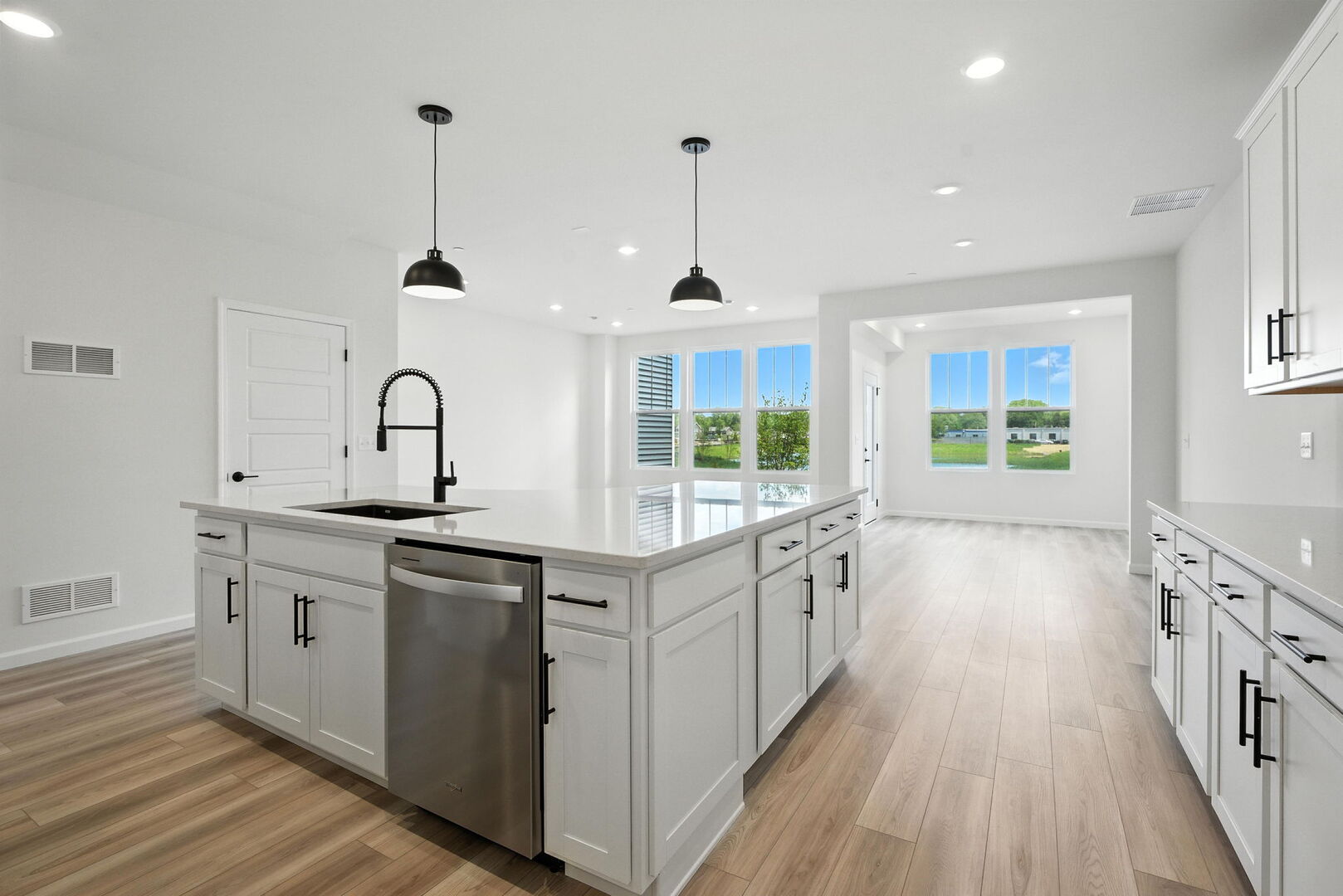 1062 Houston Street, Unit 74004 Batavia, IL 60510 - Photo 6 of 23 a kitchen with sink a stove and wooden floors