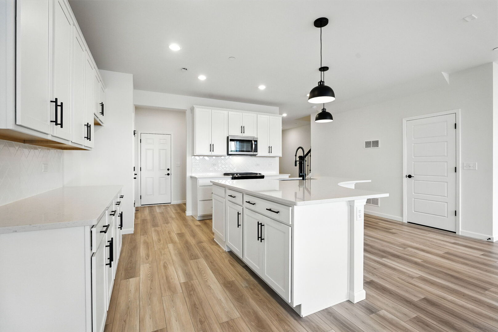 1062 Houston Street, Unit 74004 Batavia, IL 60510 - Photo 7 of 23 a kitchen with white cabinets appliances and wooden floor