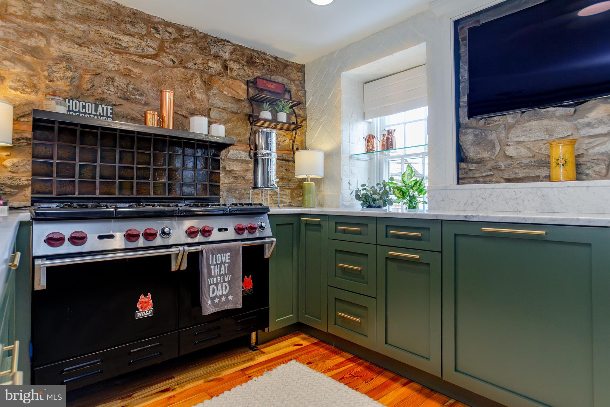 10108 Falls Road Lutherville-Timonium, MD 21093 - Photo 12 of 55 a kitchen with stainless steel appliances a stove a microwave and cabinets