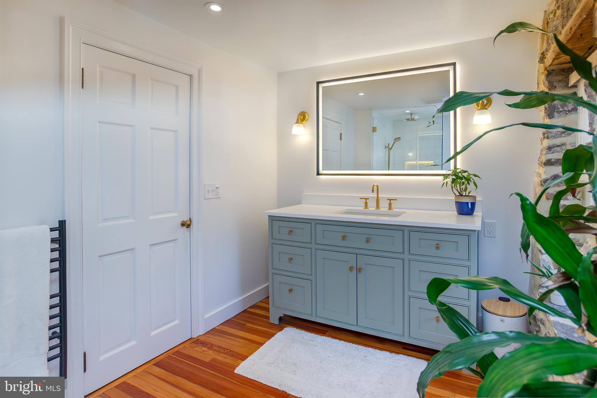 10108 Falls Road Lutherville-Timonium, MD 21093 - Photo 22 of 55 a spacious bathroom with a granite countertop sink and a mirror