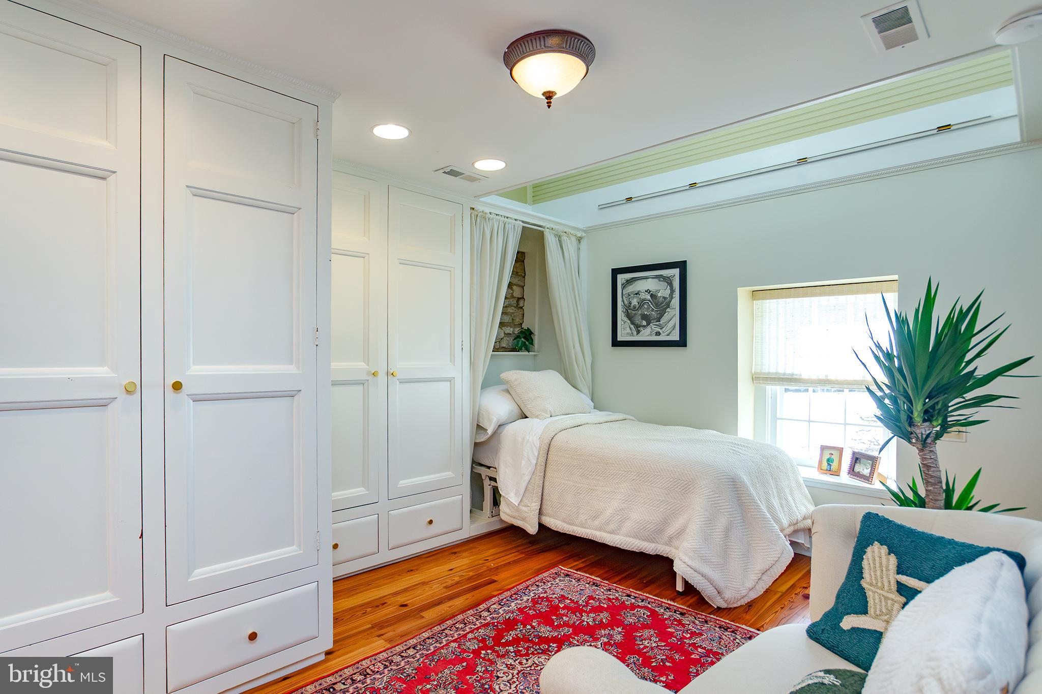 10108 Falls Road Lutherville-Timonium, MD 21093 - Photo 25 of 55 a bedroom with a bed and a potted plant