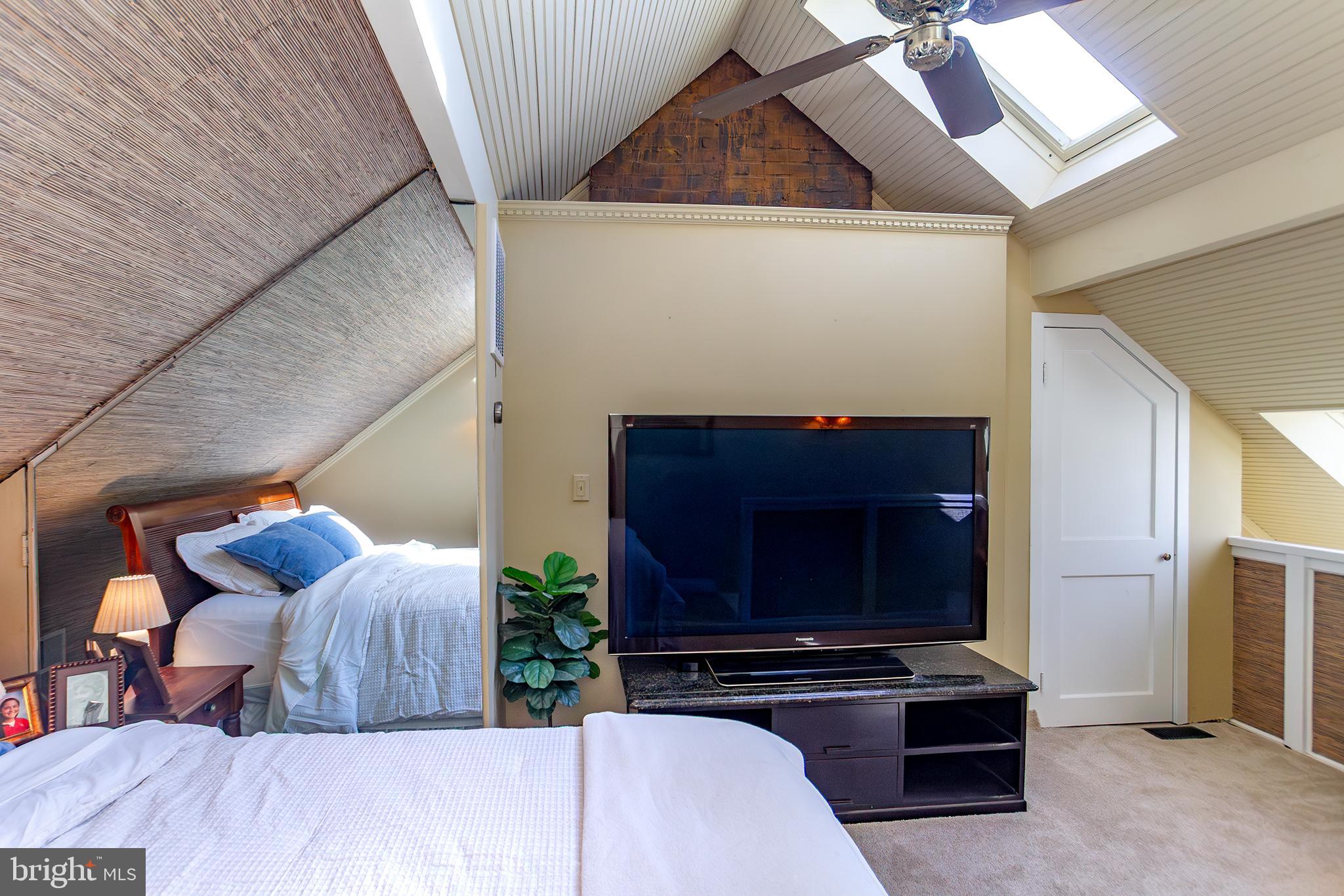10108 Falls Road Lutherville-Timonium, MD 21093 - Photo 31 of 55 a living room with furniture a flat screen tv and a fireplace