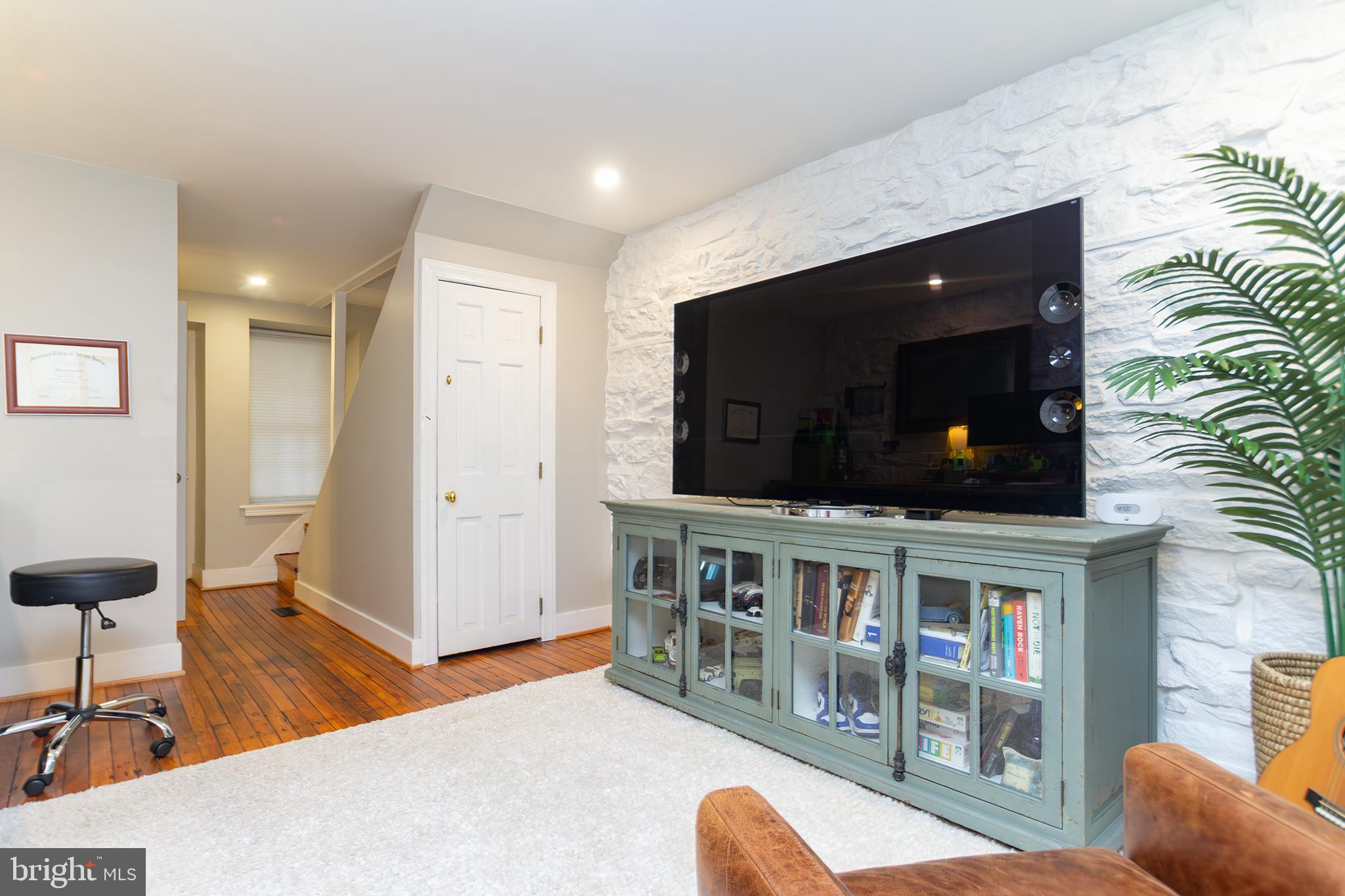 10108 Falls Road Lutherville-Timonium, MD 21093 - Photo 36 of 55 a living room with furniture and a flat screen tv