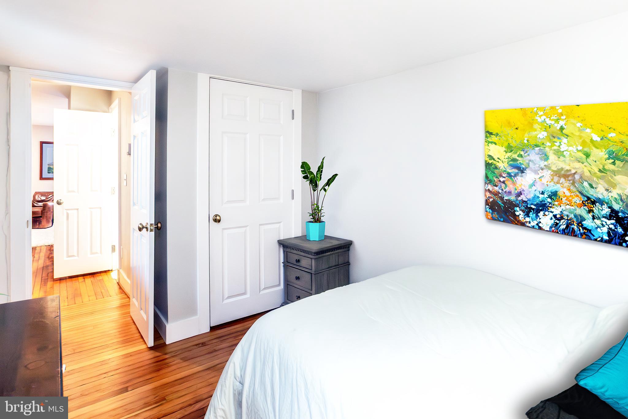 10108 Falls Road Lutherville-Timonium, MD 21093 - Photo 44 of 55 a bedroom with a bed and a painting on the wall