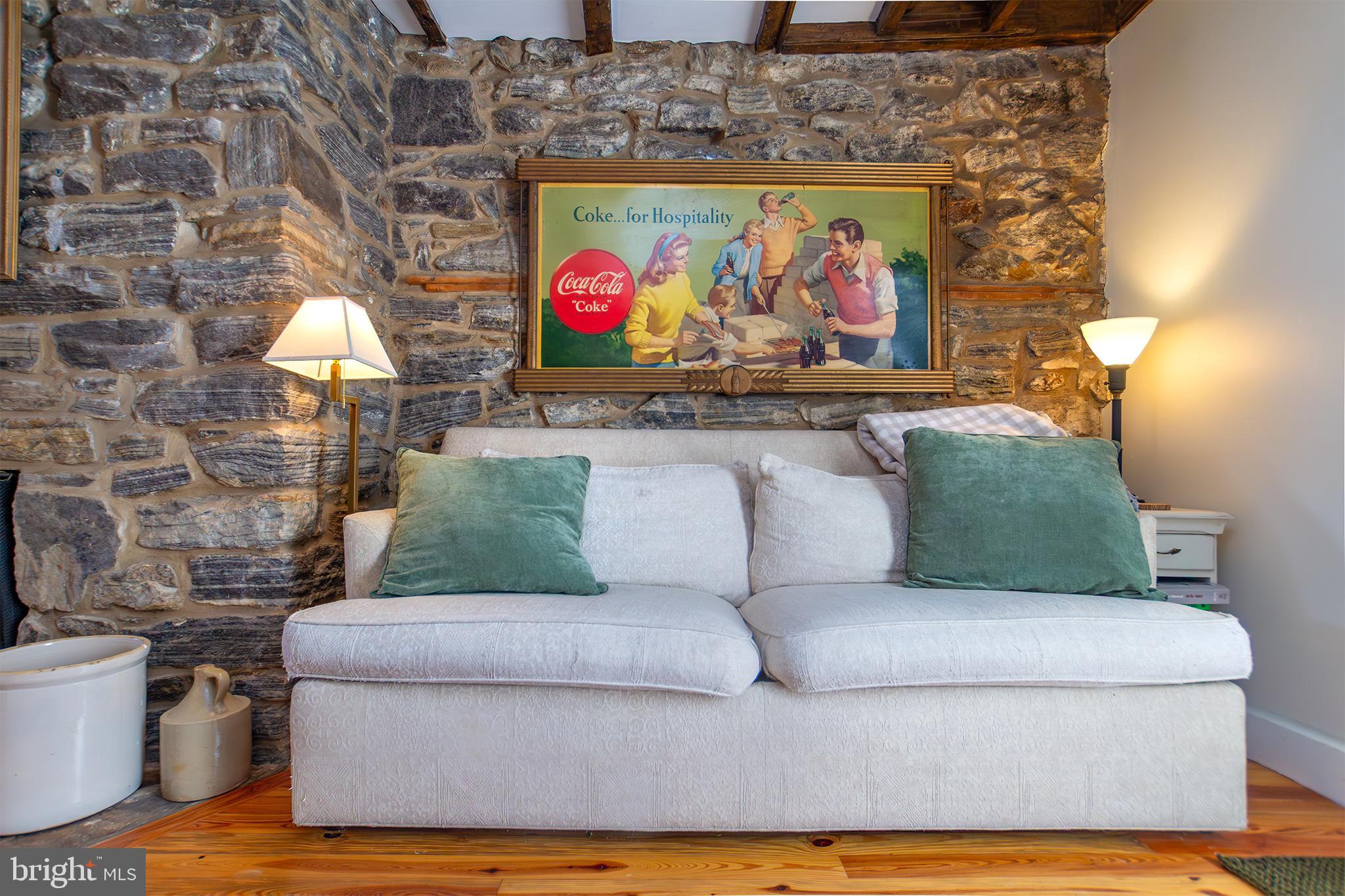 10108 Falls Road Lutherville-Timonium, MD 21093 - Photo 5 of 55 a living room with a couch and a painting on the wall