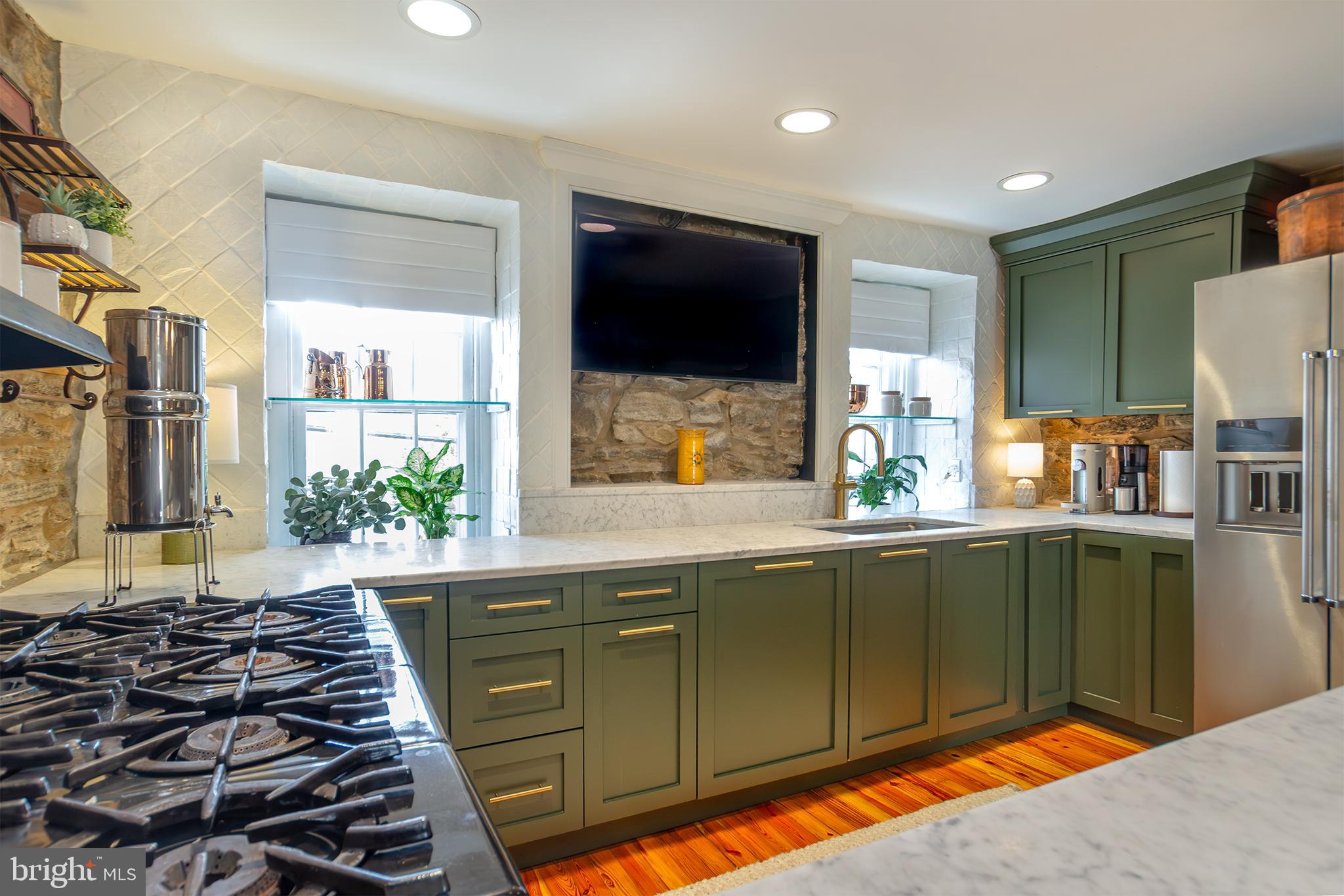10108 Falls Road Lutherville-Timonium, MD 21093 - Photo 10 of 55 a kitchen with a sink and a stove top oven