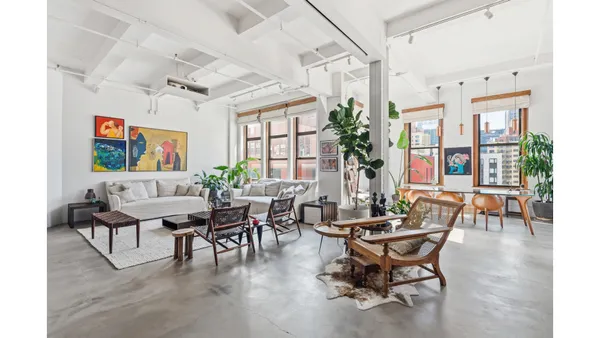 a view of a livingroom with furniture and a potted plant