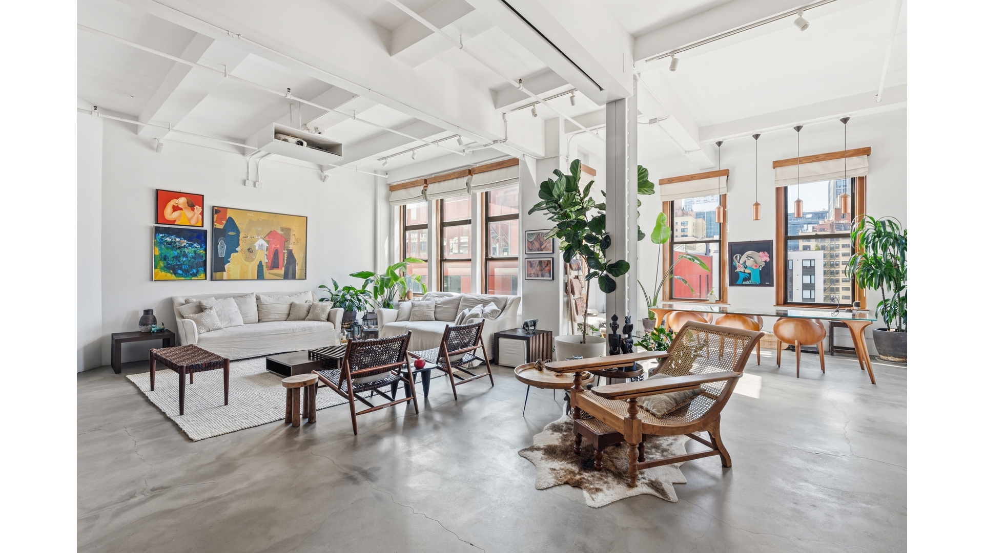 a view of a livingroom with furniture and a potted plant