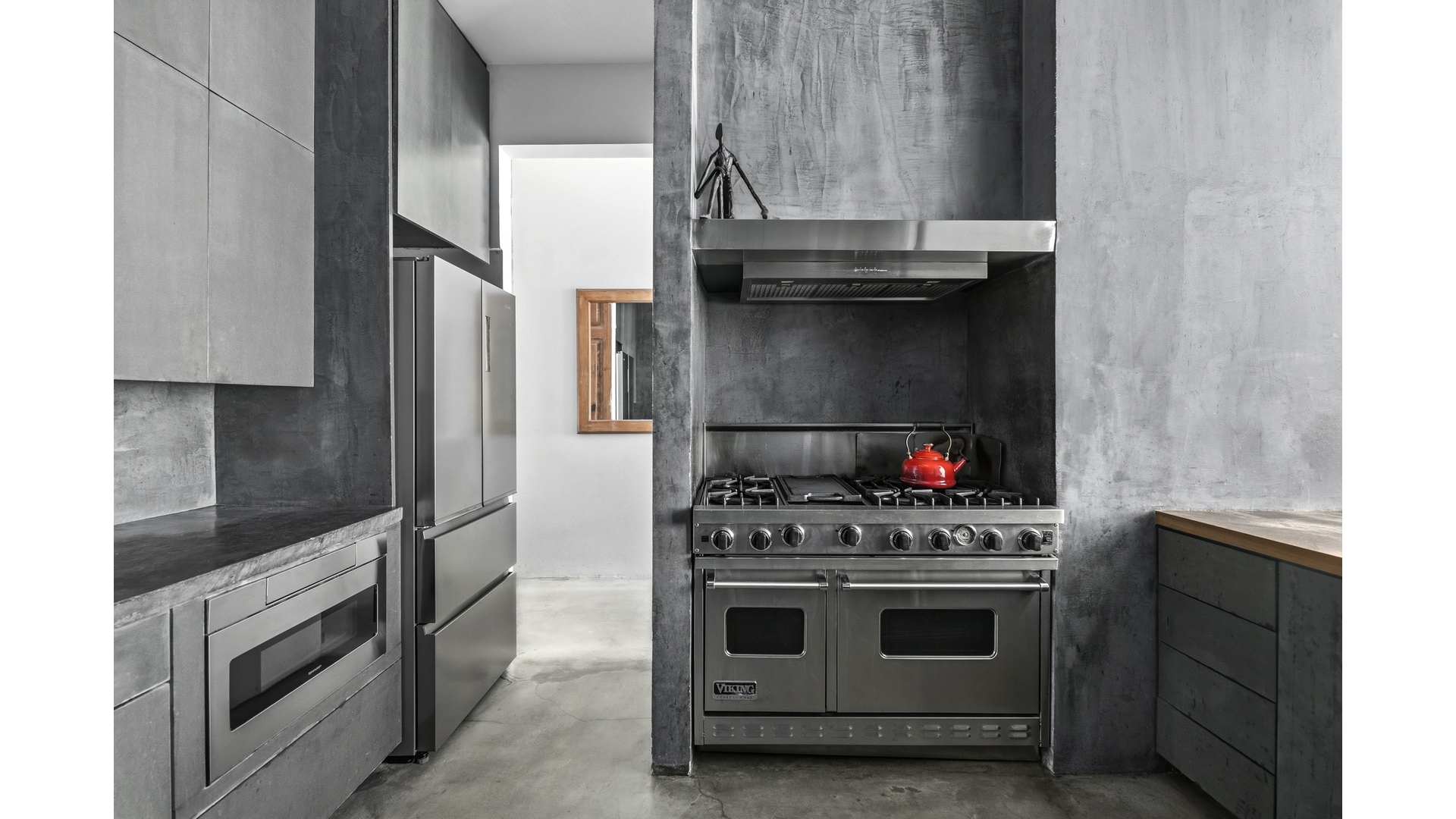 448 West 37th Street, Unit 9G Manhattan, NY 10018 - Photo 5 of 15 a kitchen with stainless steel appliances granite countertop a stove and a refrigerator