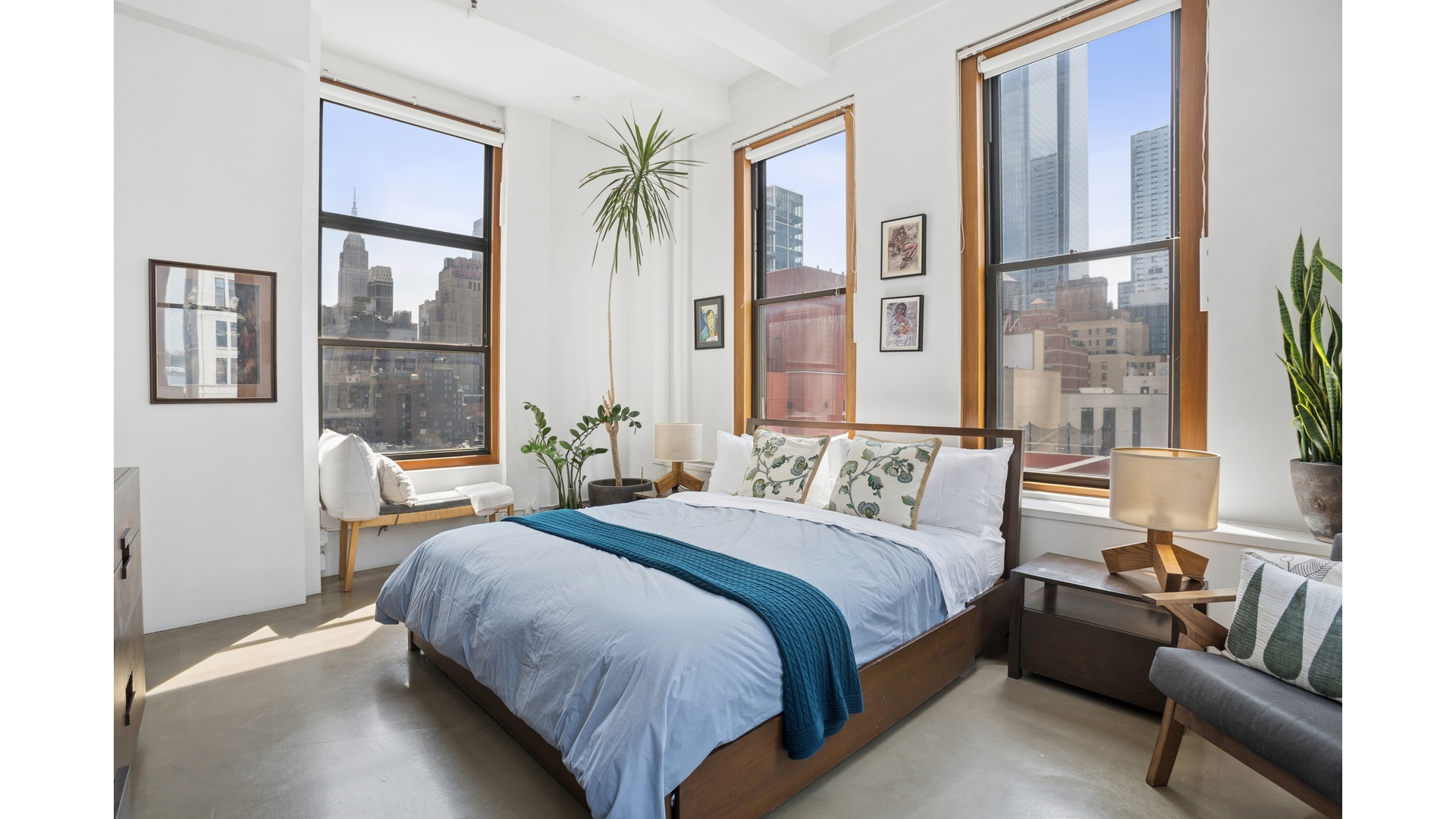 448 West 37th Street, Unit 9G Manhattan, NY 10018 - Photo 9 of 15 a bedroom with a bed wooden floor and a large window