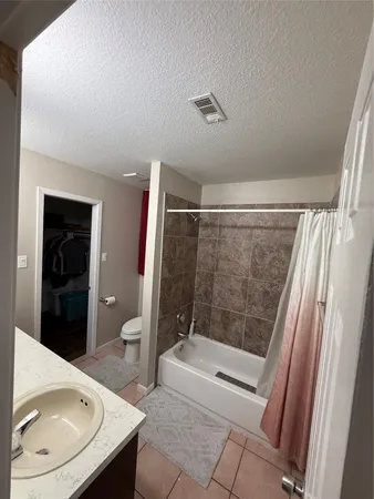 a bedroom with a bed and a television