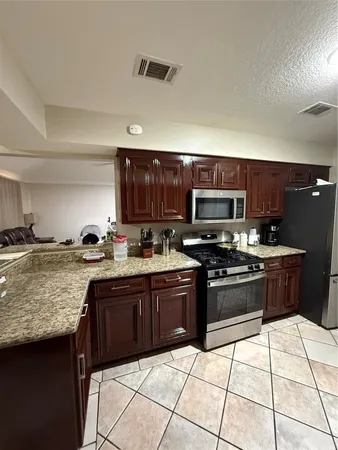a living room with furniture a clock and a flat screen tv