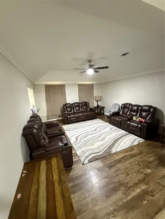 a view of a livingroom with furniture and staircase