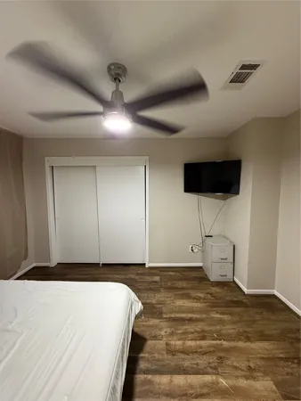 a view of a hallway and a livingroom with furniture