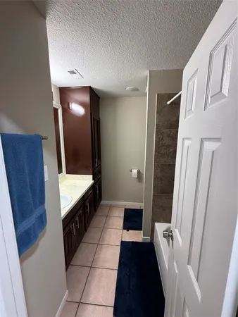 a bathroom with a sink vanity and mirror
