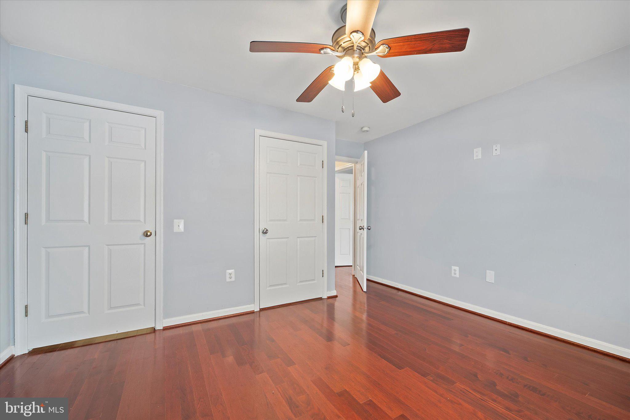 9253 Cardinal Forest Lane, Unit 101 Lorton, VA 22079 - Photo 10 of 29 an empty room with wooden floor and windows