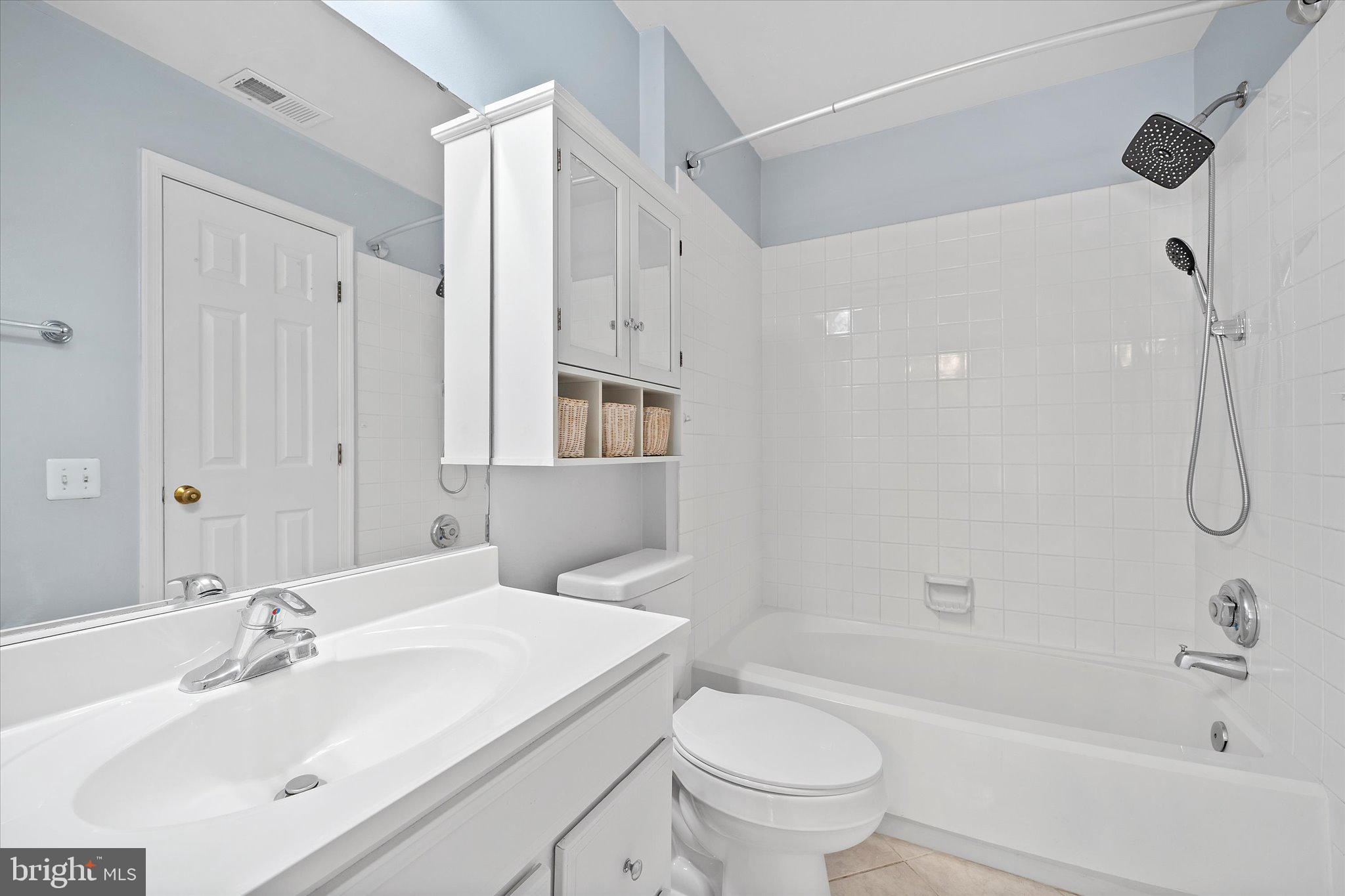 9253 Cardinal Forest Lane, Unit 101 Lorton, VA 22079 - Photo 12 of 29 a bathroom with a sink toilet and shower