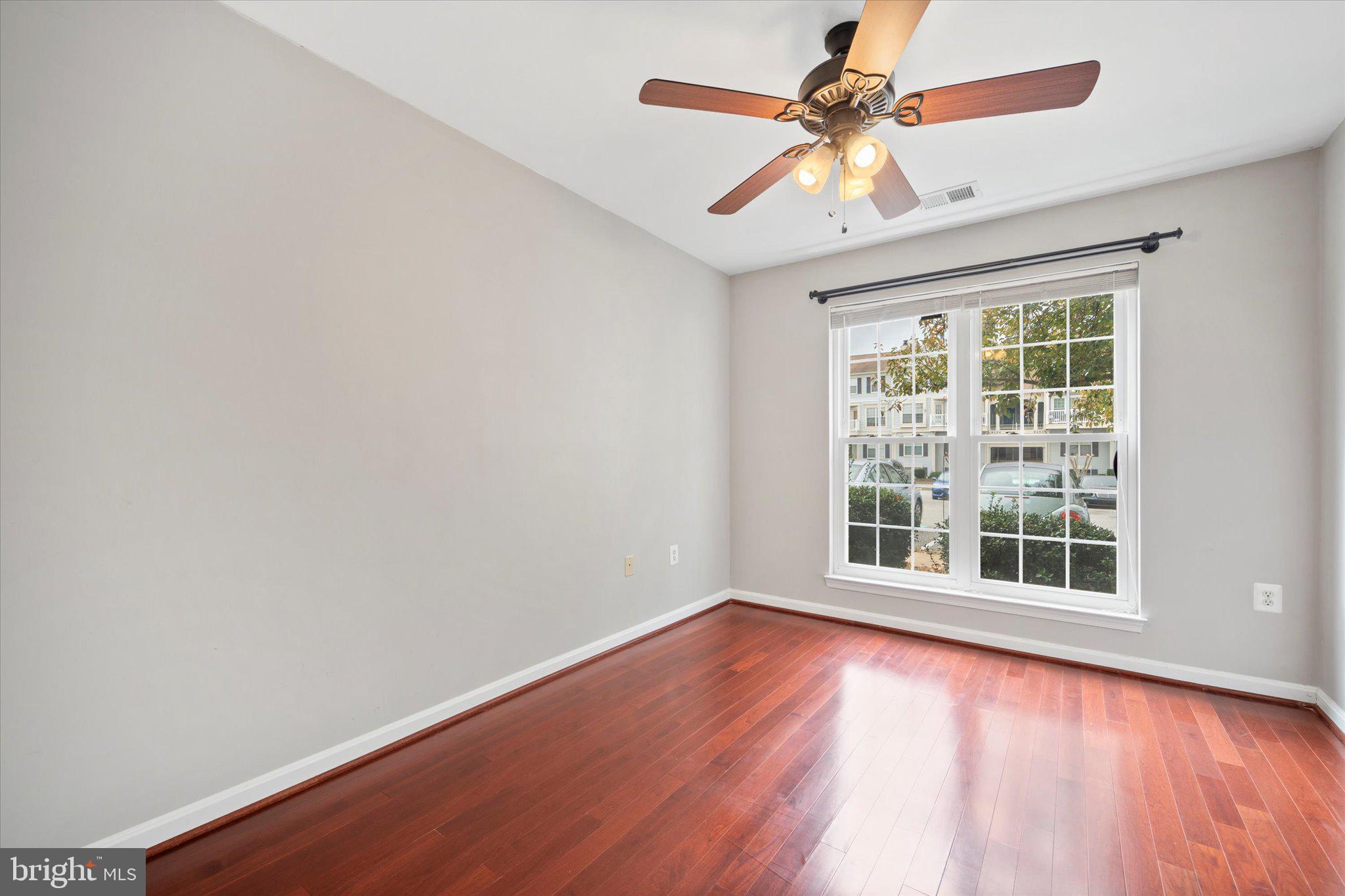 9253 Cardinal Forest Lane, Unit 101 Lorton, VA 22079 - Photo 14 of 29 wooden floor in an empty room with a window