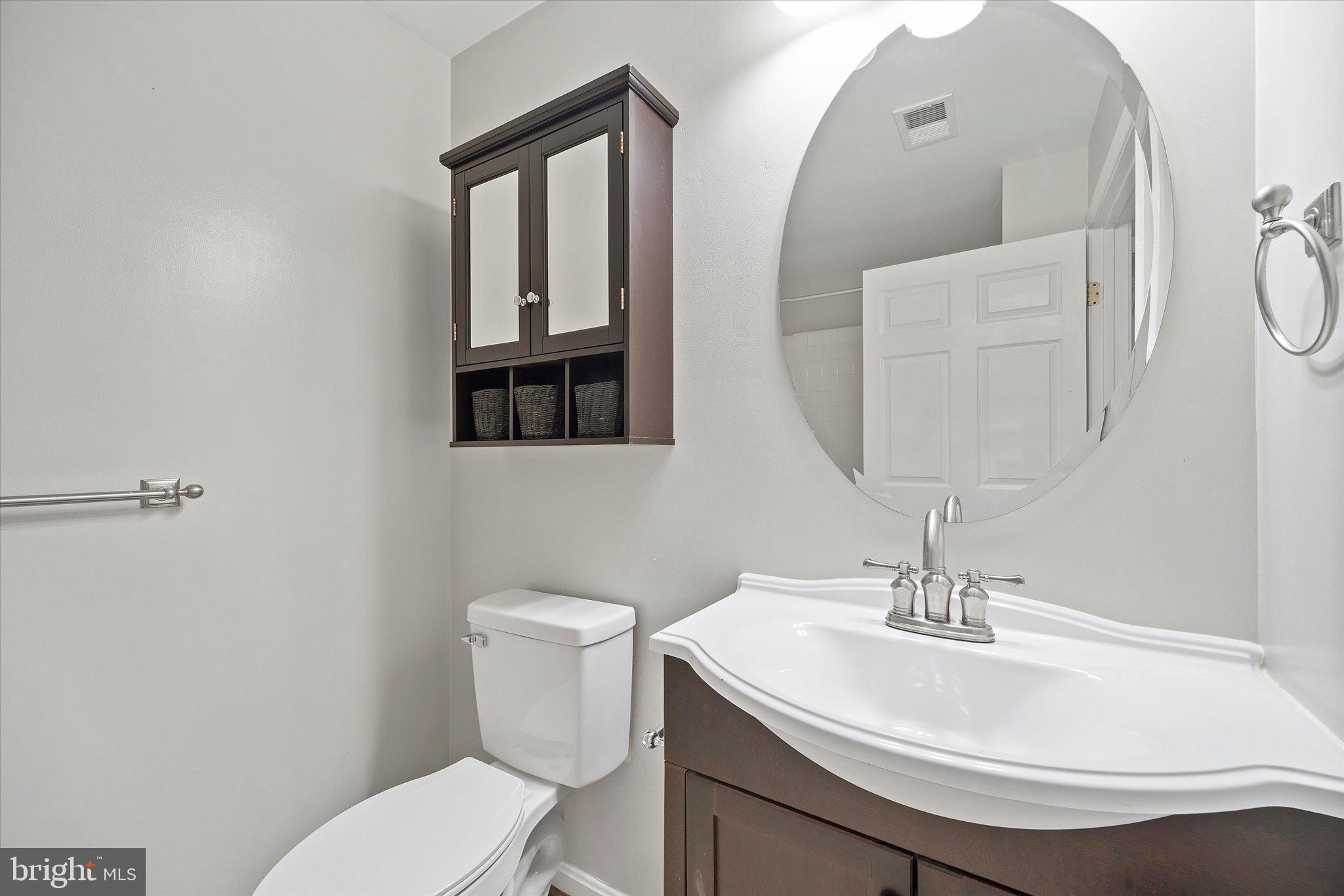 9253 Cardinal Forest Lane, Unit 101 Lorton, VA 22079 - Photo 15 of 29 a bathroom with a sink toilet and mirror