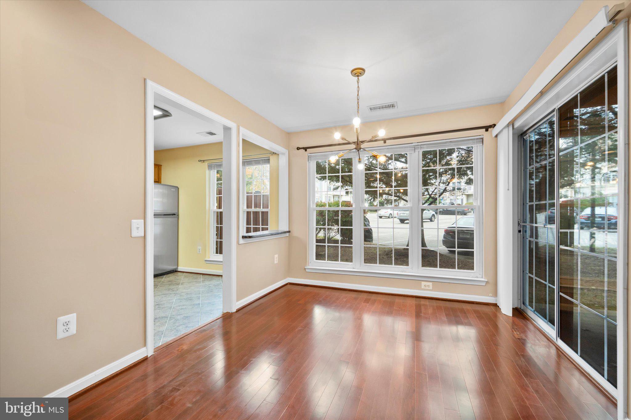 9253 Cardinal Forest Lane, Unit 101 Lorton, VA 22079 - Photo 18 of 29 a view of empty room with wooden floor and fan
