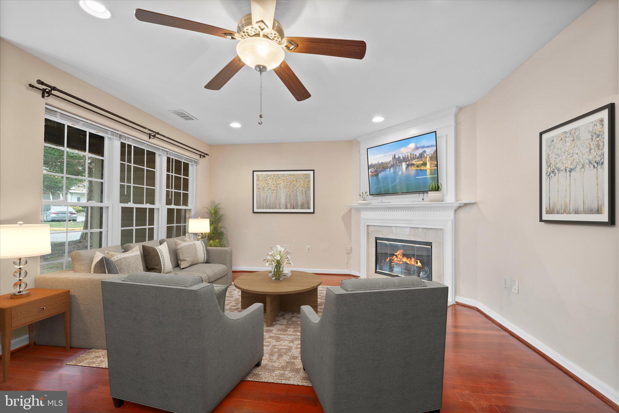 9253 Cardinal Forest Lane, Unit 101 Lorton, VA 22079 - Photo 3 of 29 a living room with furniture and a fireplace