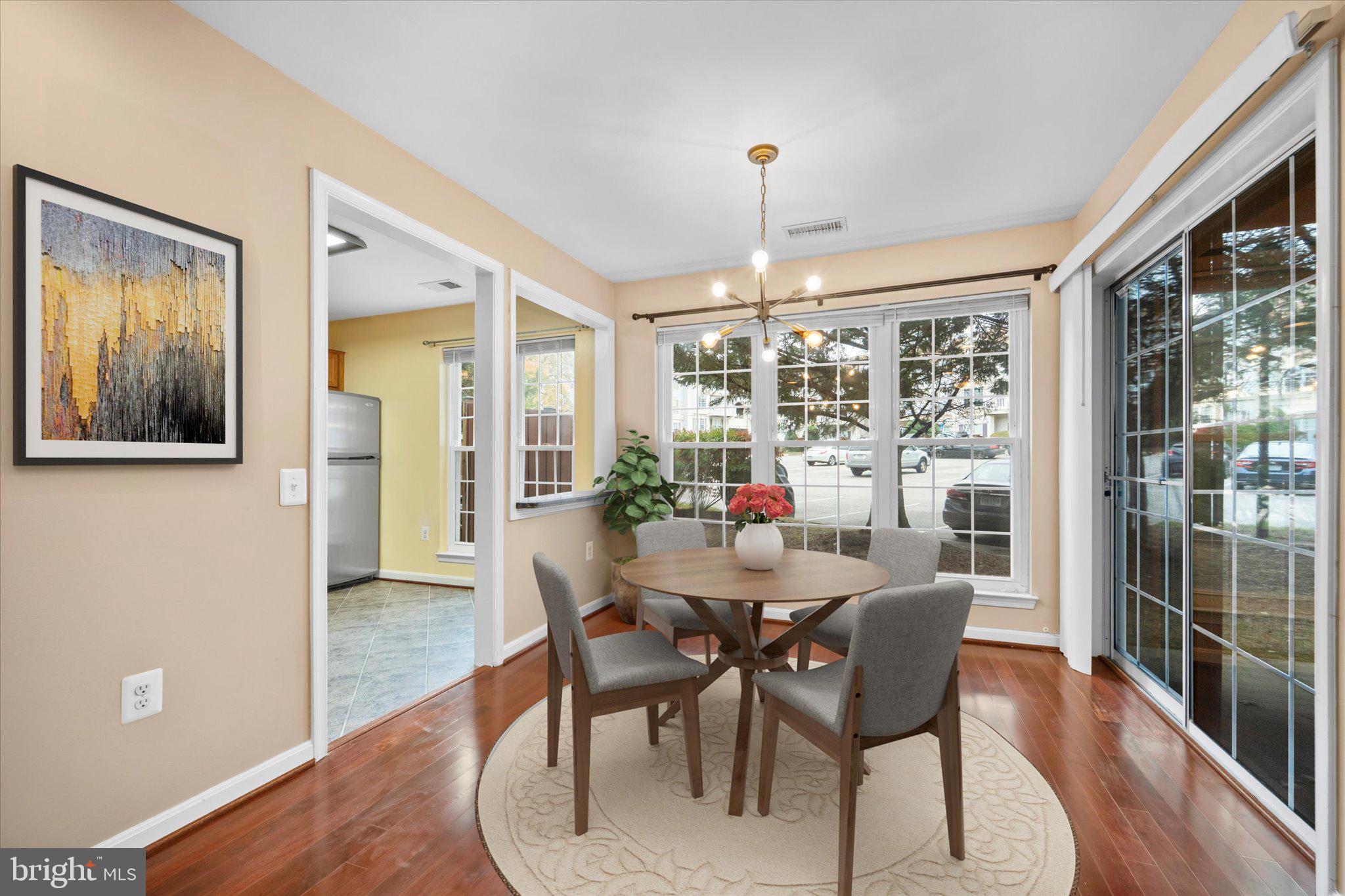 9253 Cardinal Forest Lane, Unit 101 Lorton, VA 22079 - Photo 4 of 29 a view of a dining room with furniture window and wooden floor