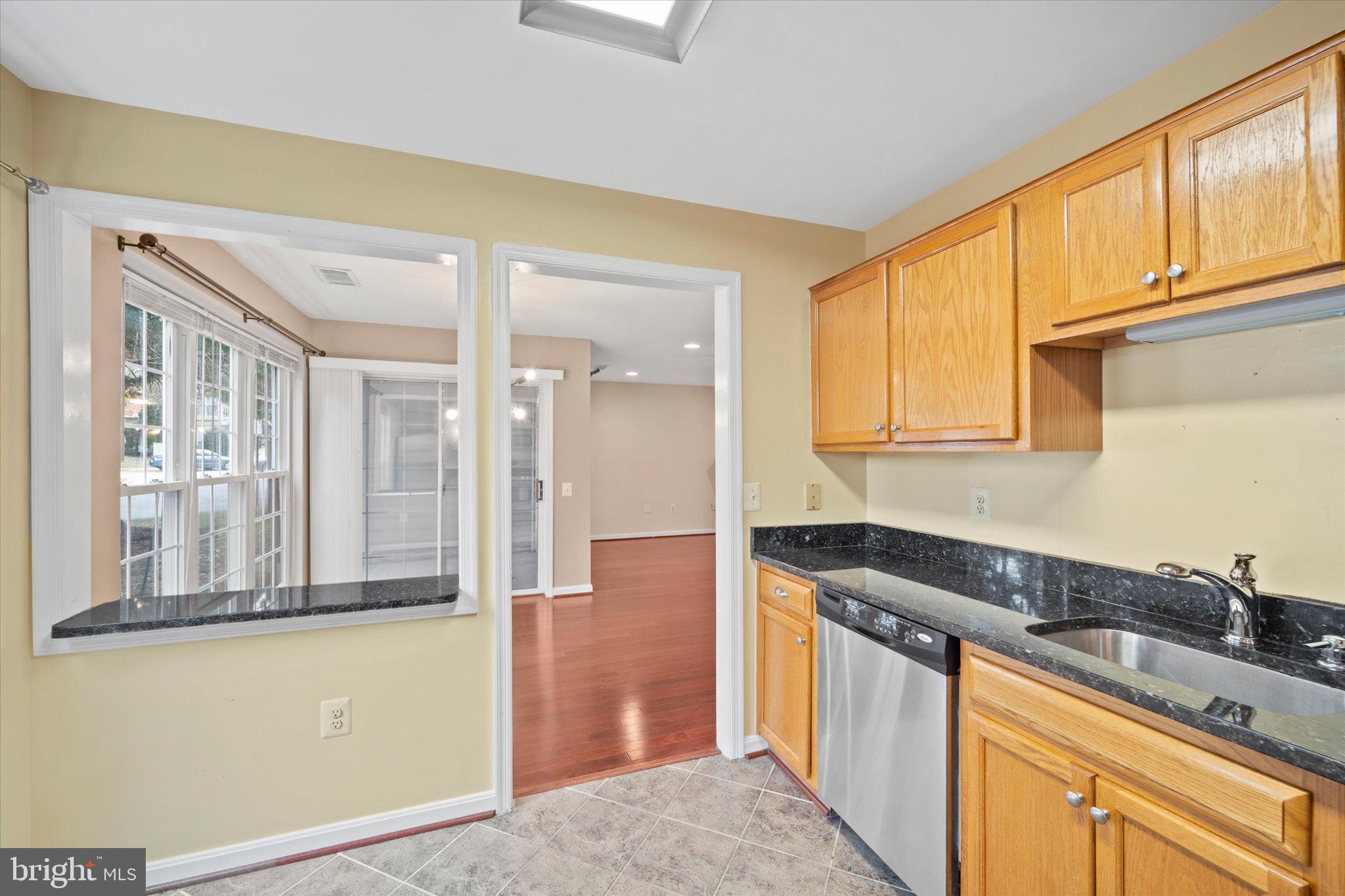 9253 Cardinal Forest Lane, Unit 101 Lorton, VA 22079 - Photo 5 of 29 a kitchen that has a sink and a stove