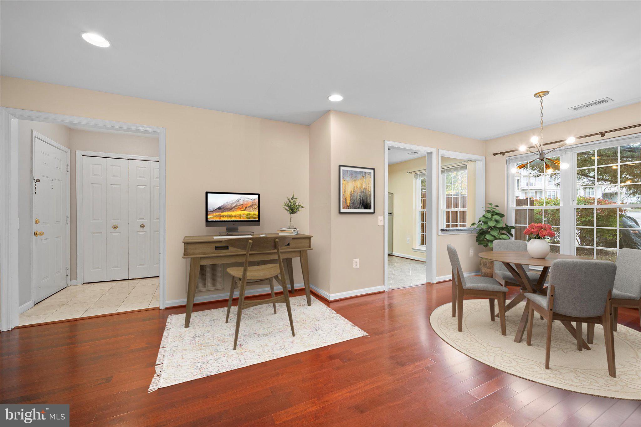 9253 Cardinal Forest Lane, Unit 101 Lorton, VA 22079 - Photo 7 of 29 a living room with furniture a dining table and a potted plant