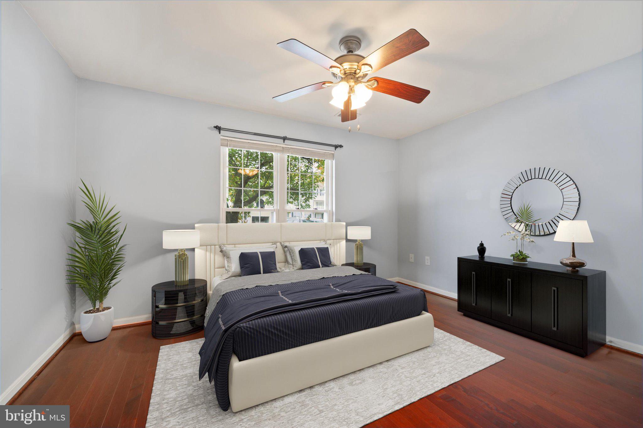 9253 Cardinal Forest Lane, Unit 101 Lorton, VA 22079 - Photo 8 of 29 a bedroom with a large bed and a chandelier