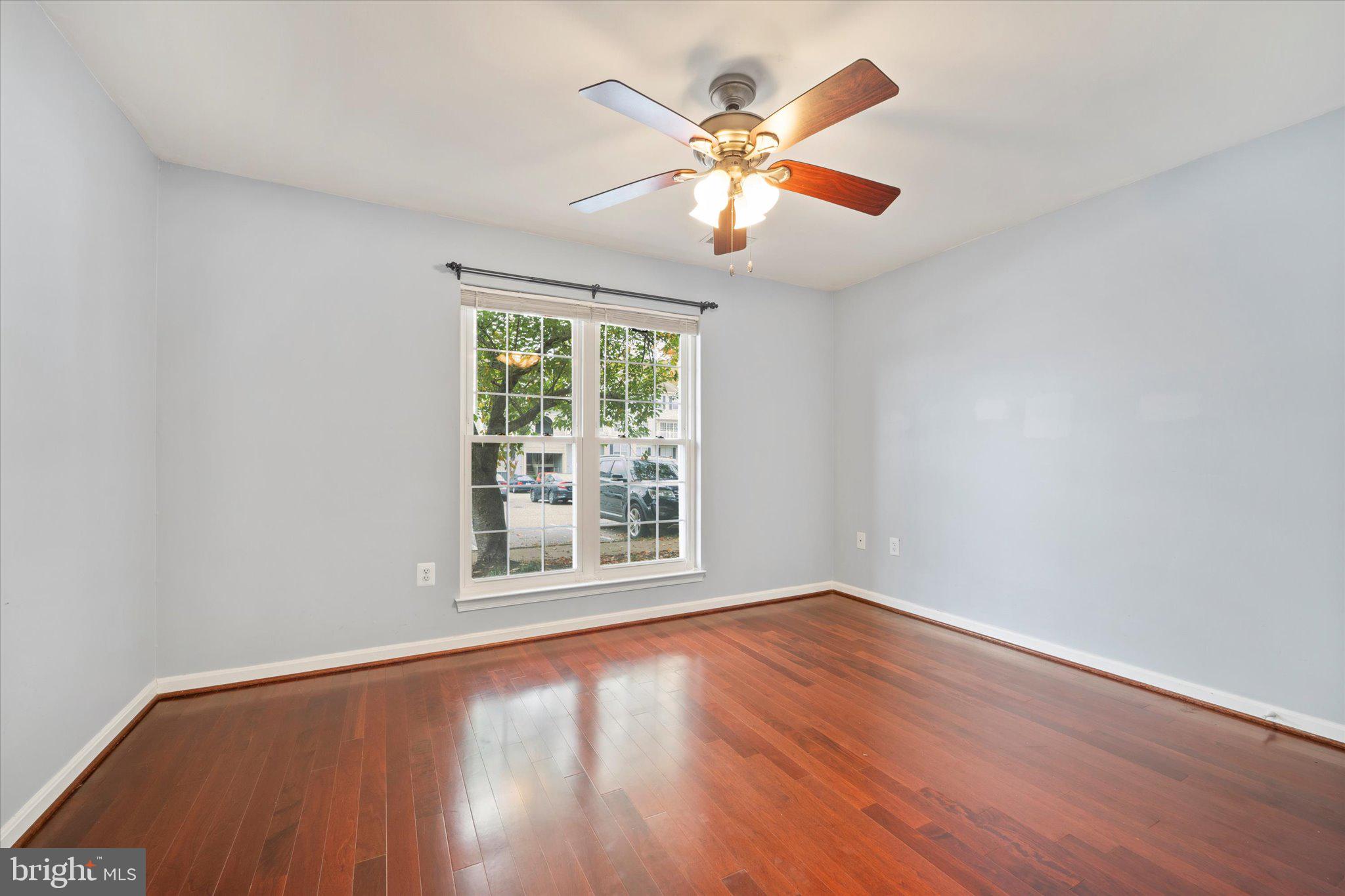 9253 Cardinal Forest Lane, Unit 101 Lorton, VA 22079 - Photo 9 of 29 an empty room with wooden floor and windows
