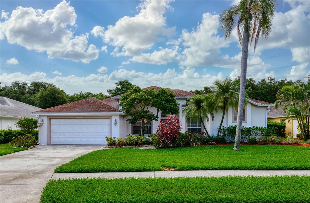 2810 89th Avenue East Parrish, FL 34219 - Photo 1 of 34 a front view of a house with a garden and trees