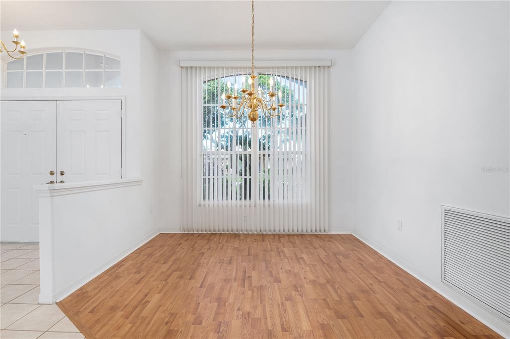 2810 89th Avenue East Parrish, FL 34219 - Photo 11 of 34 an empty room with wooden floor and windows